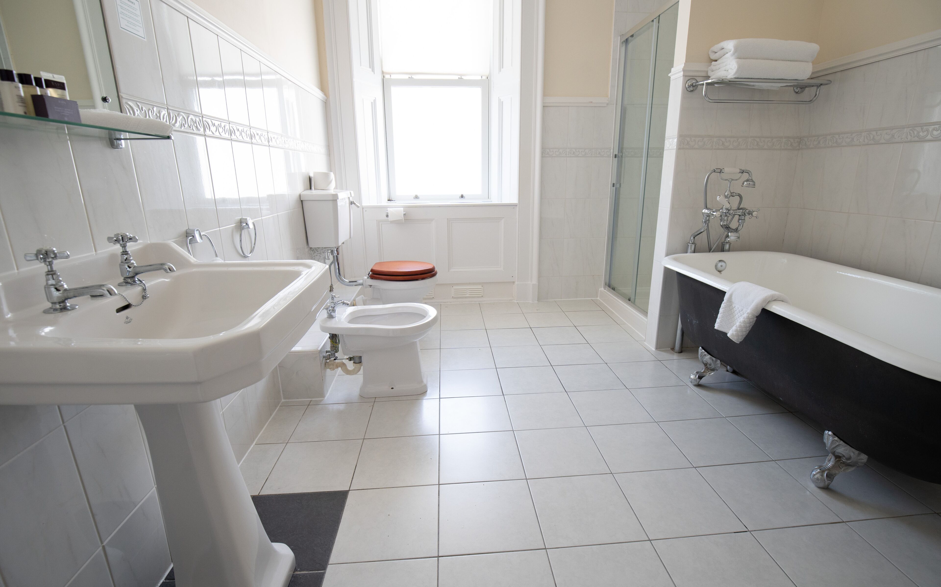 A bathroom with a sink, toilet, bathtub, and shower.