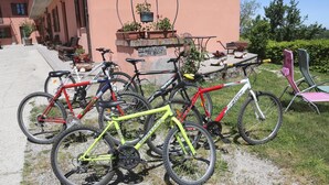 A row of bicycles parked in front of a building with a sign that reads "Albergo al Brico". - Al Brich (Albaretto della Torre)