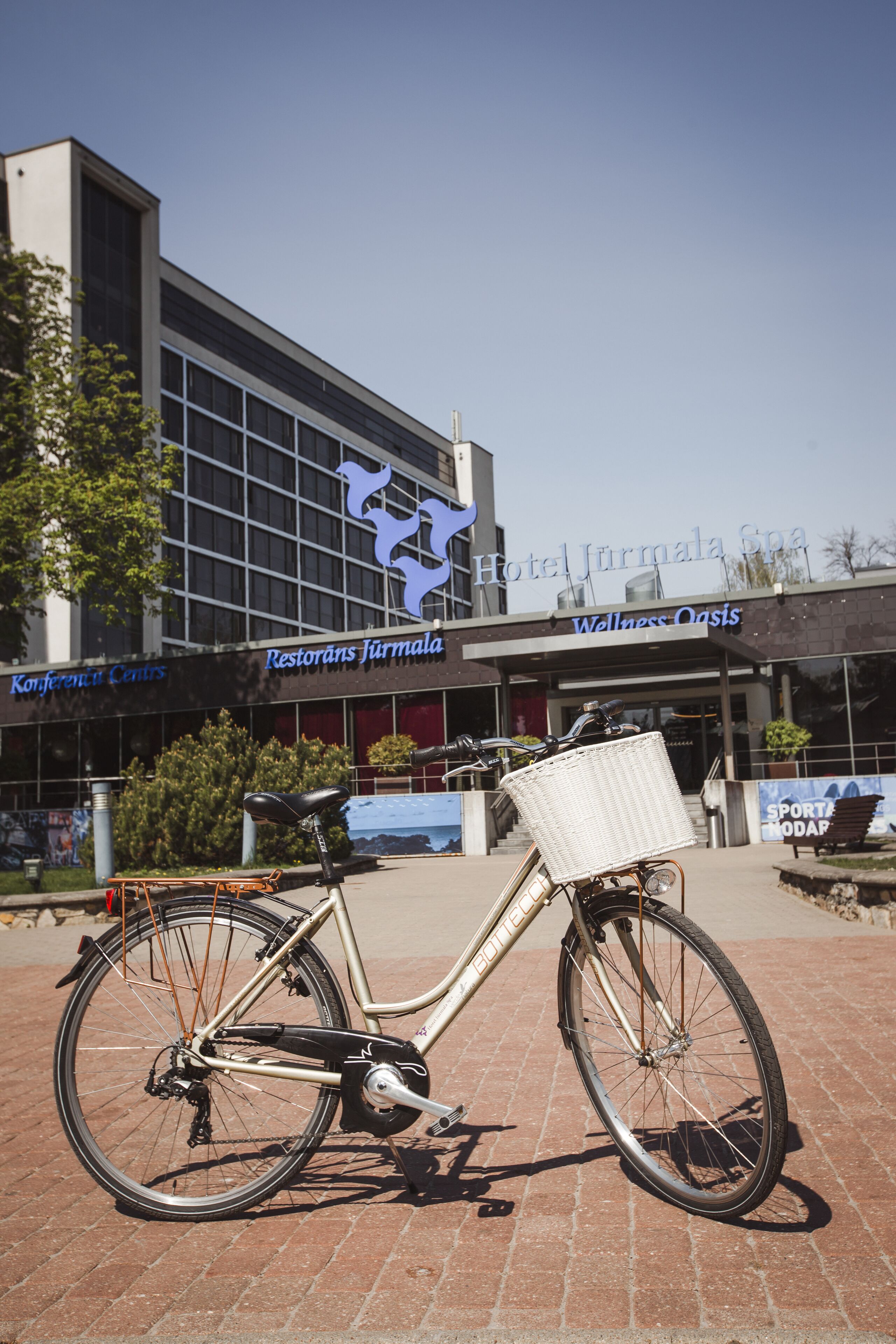 A bicycle parked in front of Hotel Jätkä, with a clear view of the building's entrance and signage.