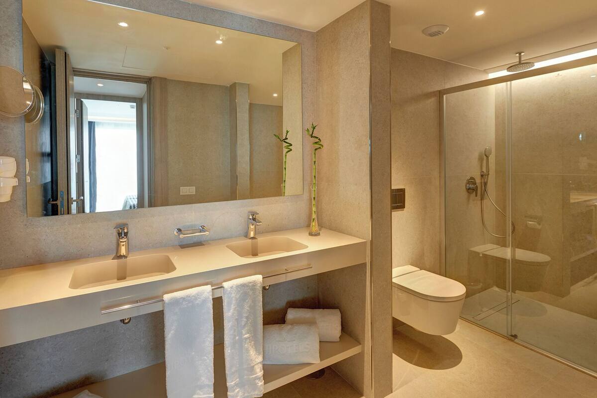 shower, rainfall showerhead, hair dryer, towels