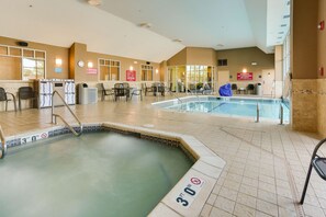 An indoor swimming pool with a 30 ft depth sign, a reception area, and a 'No Lifeguard' warning sign. - Drury Inn & Suites West Des Moines (West Des Moines)