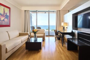 A modern hotel room with a sofa, coffee table, dining table, and TV. - Adriatic Istria Resort Operated by Minor Hotels (Umag)