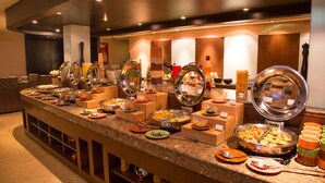 A buffet setup with various food stations and serving utensils. - Ellaa Hotel Gachibowli (Hyderabad)