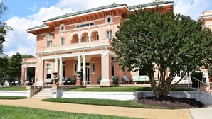A large, two-story building with a symmetrical facade, columns, and a central entrance. - JH Adams Inn, Trademark Collection by Wyndham (High Point)