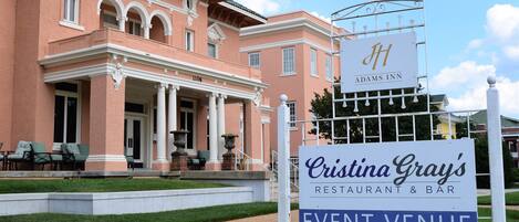 A building with a sign for 'Cristina Gray's Restaurant & Bar' and 'Adams Inn' with a classic architectural style.