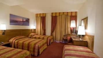 A hotel room with four single beds, a large window with curtains, a painting on the wall, and two bedside lamps.