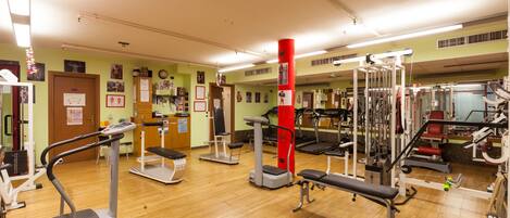 A gym with treadmills, elliptical machines, and weight equipment.