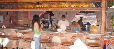A bar area with wooden stools and a counter.