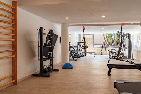 A gym with exercise equipment, a wooden ladder, and a view of the outdoors. - Cala Millor Garden, Adults Only (Sant Llorenc des Cardassar)
