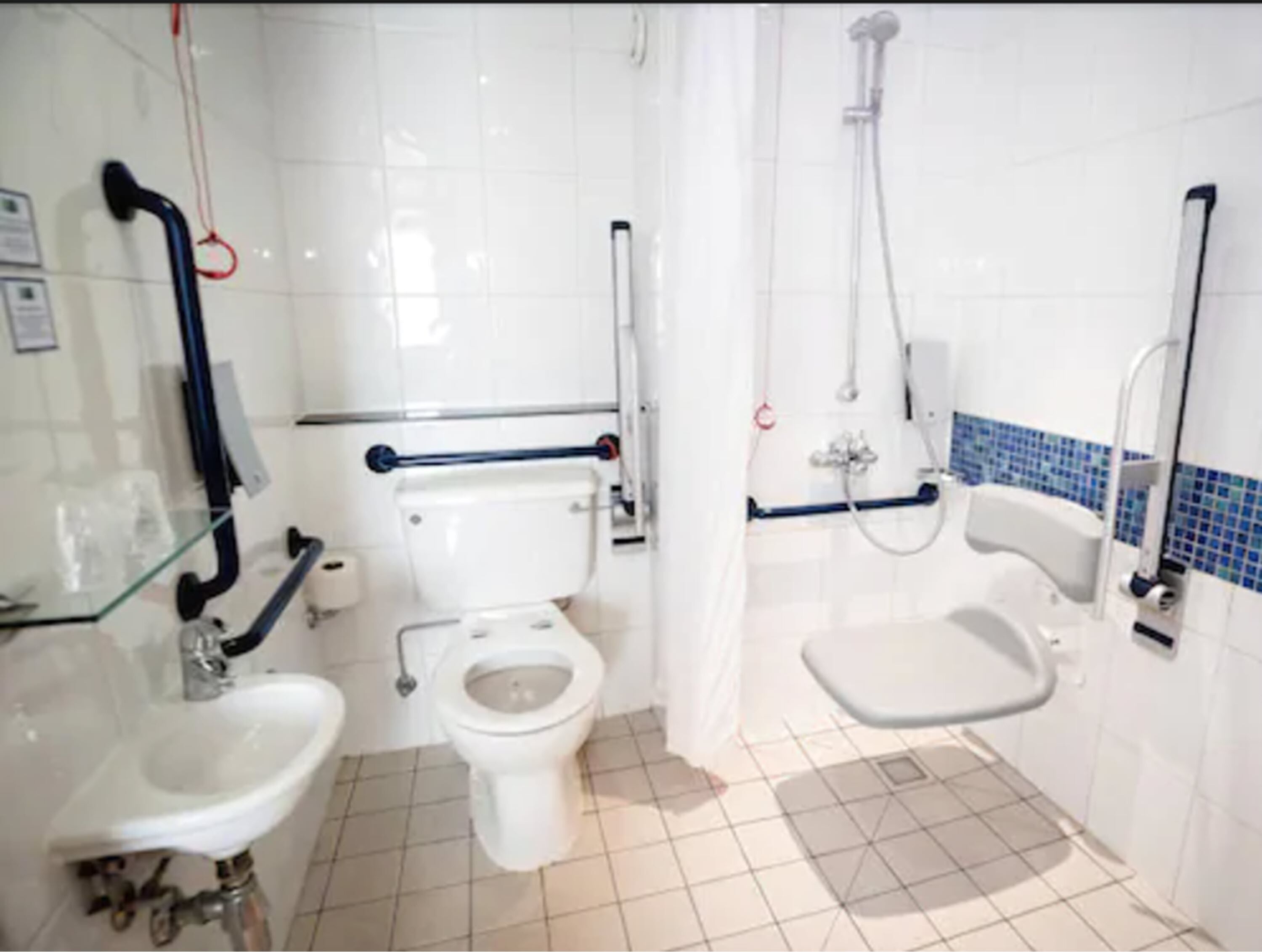 A bathroom with a toilet, bidet, and sink.