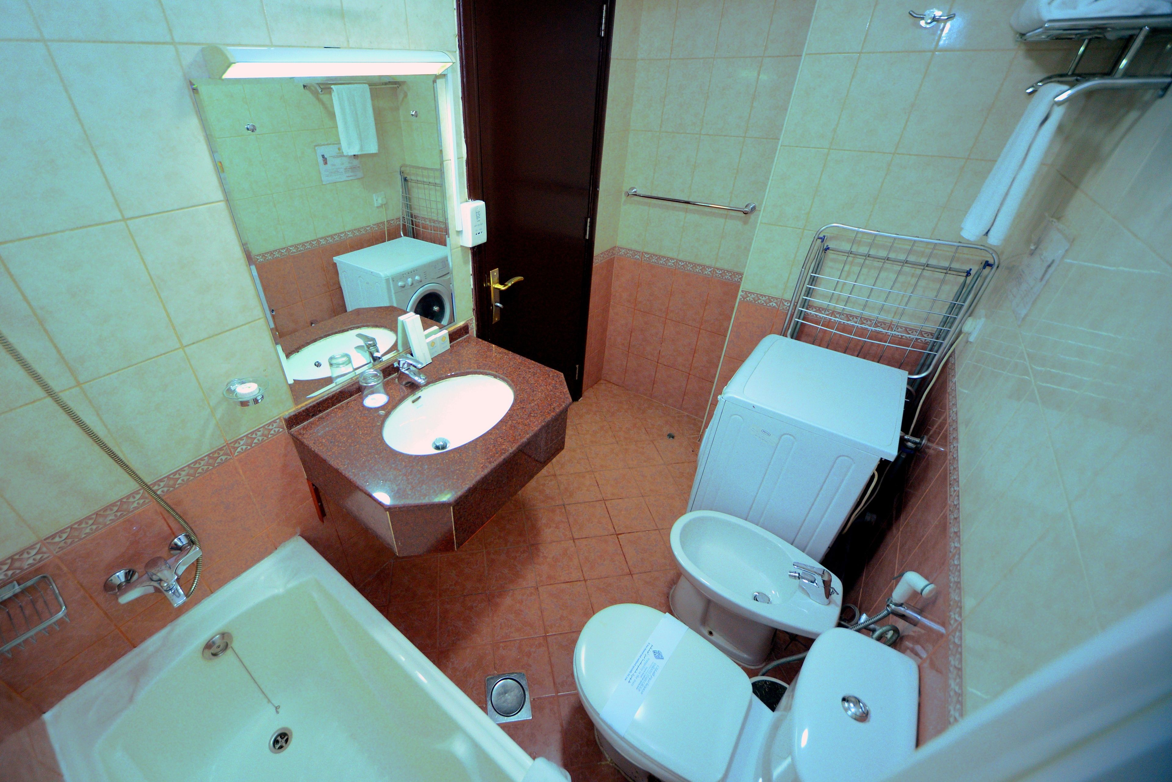 A bathroom with a sink, toilet, and bathtub.