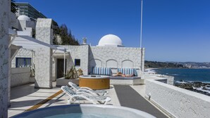 A rooftop pool area with lounge chairs, a hot tub, and a view of the sea. - MR Mar Suites (Vina del Mar)