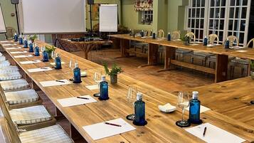 A conference room with long tables, chairs, and a whiteboard.