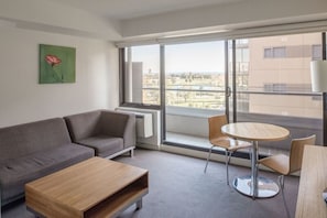 Deluxe One Bedroom Apartment | Living area | LED TV