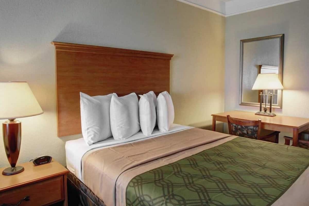 Desk, laptop workspace, blackout drapes, iron/ironing board