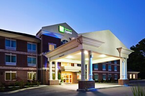 A Holiday Inn Express building with a covered entrance and a brick facade. - Holiday Inn Express & Suites Carrollton by IHG (Carrollton)