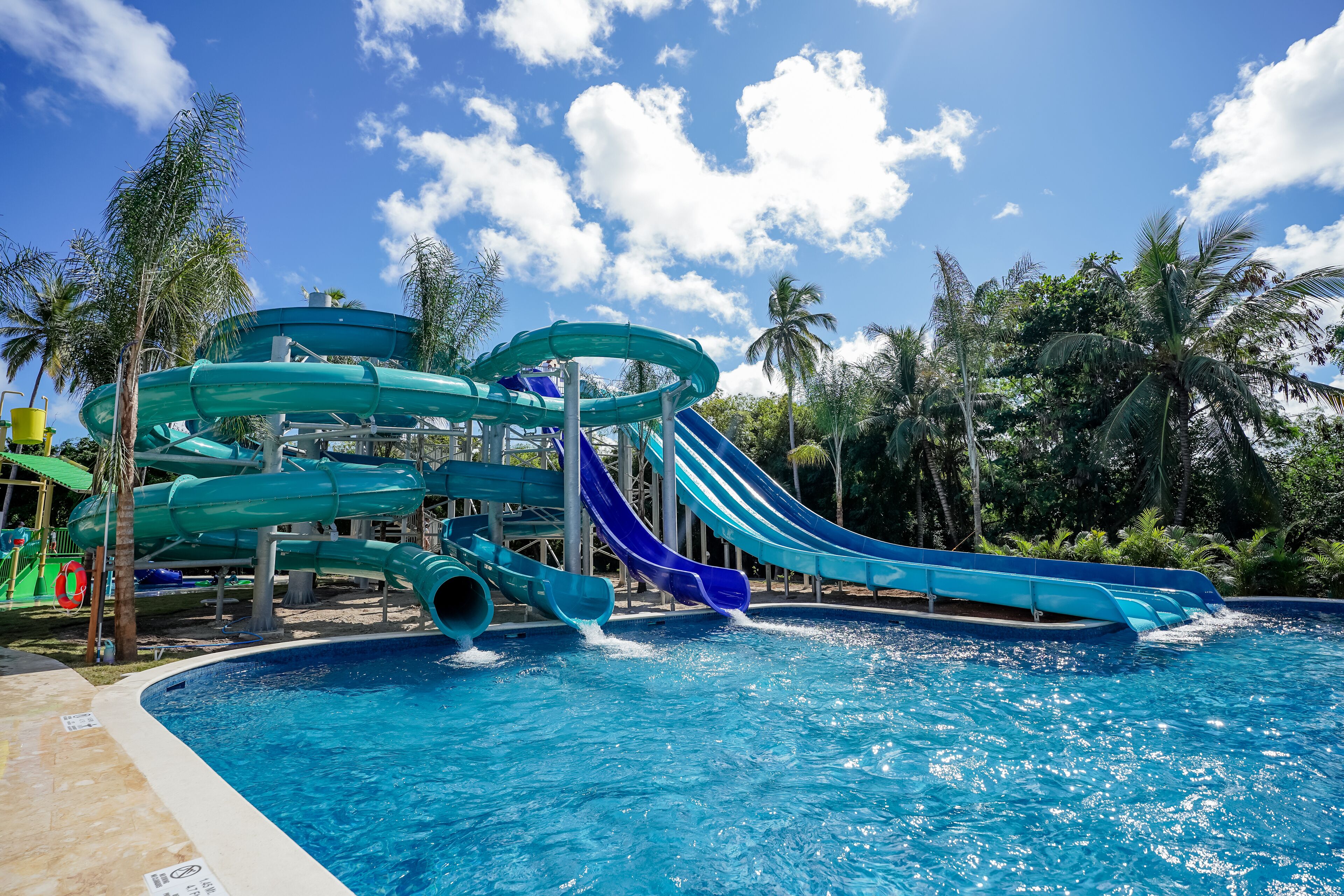 A water park with multiple slides and a pool.