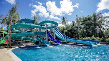 A water park with multiple slides and a pool.