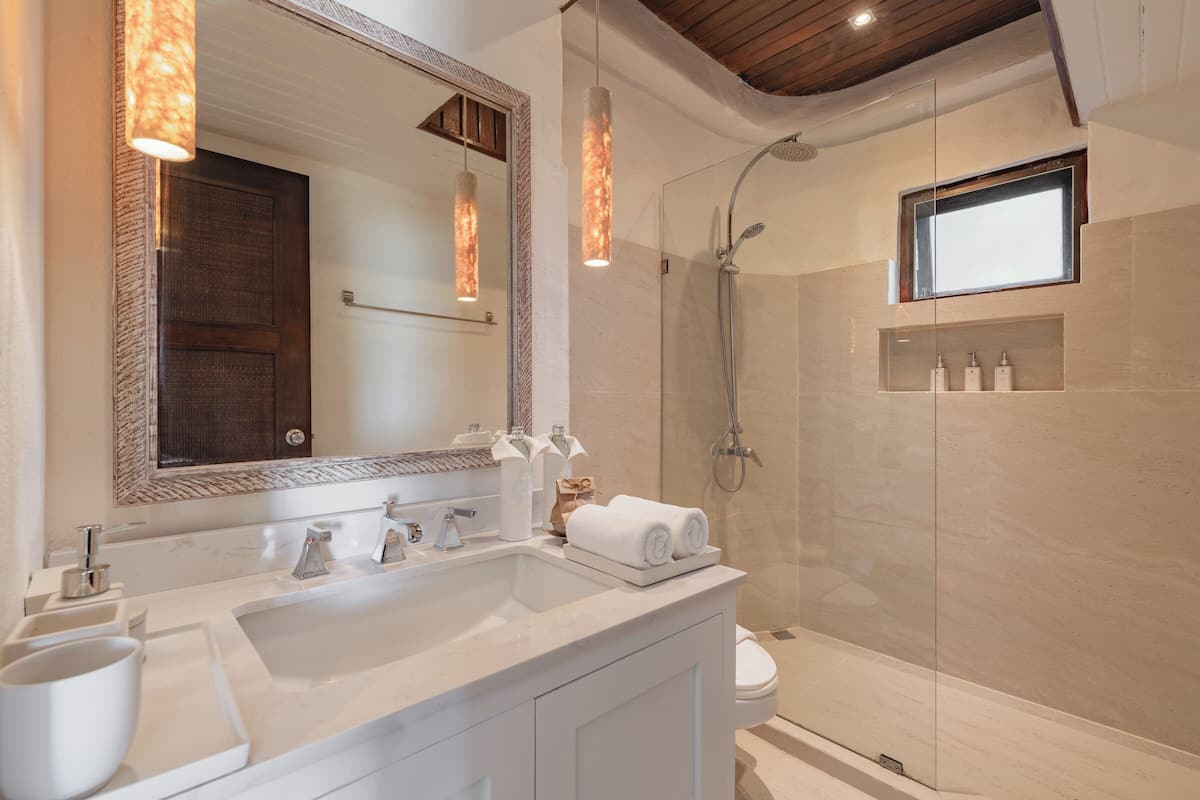 beachfront pool suite | bathroom | eco-friendly toiletries, hair dryer, bathrobes, slippers