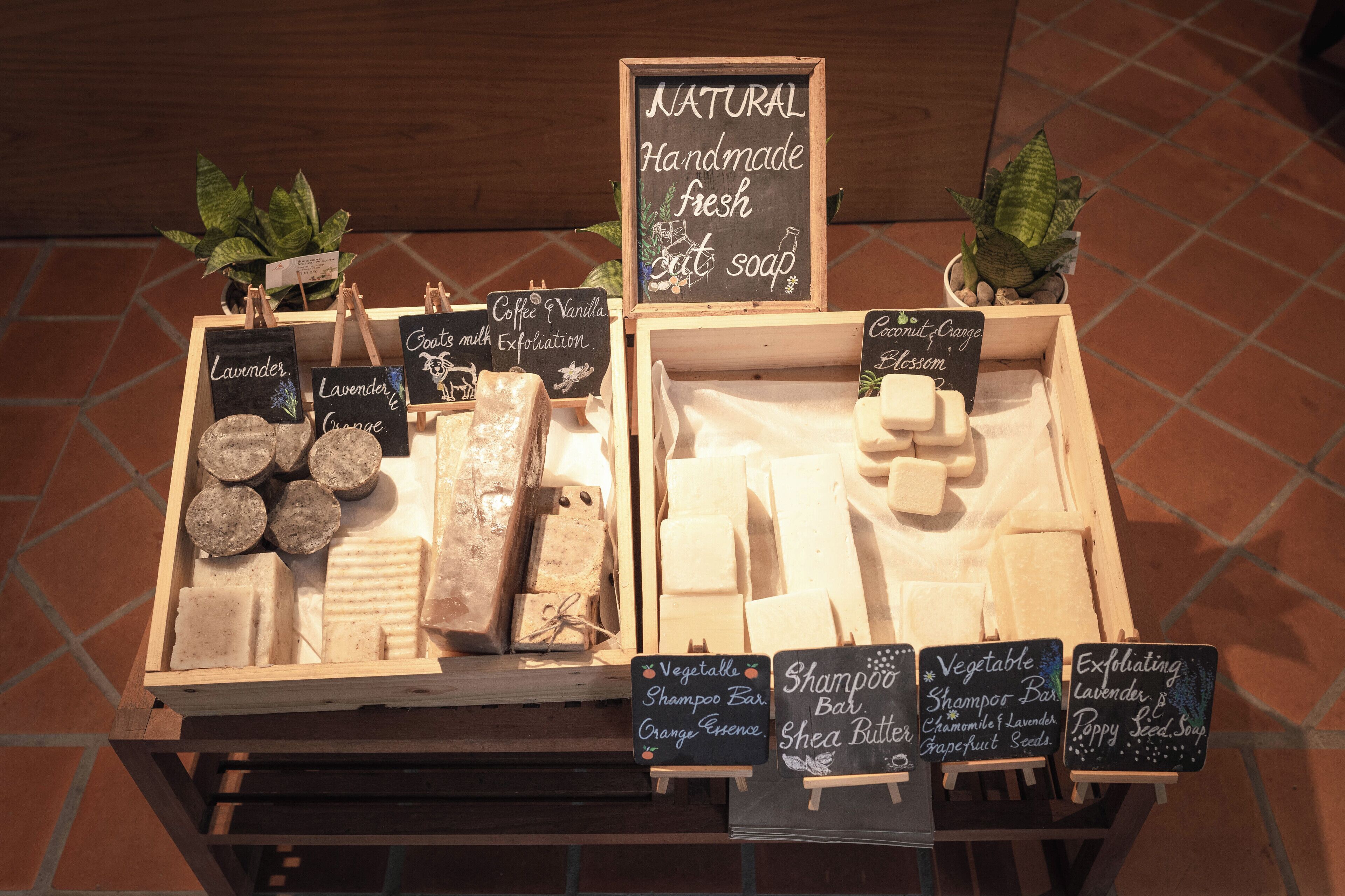 A display of natural handmade soaps with various scents and ingredients.