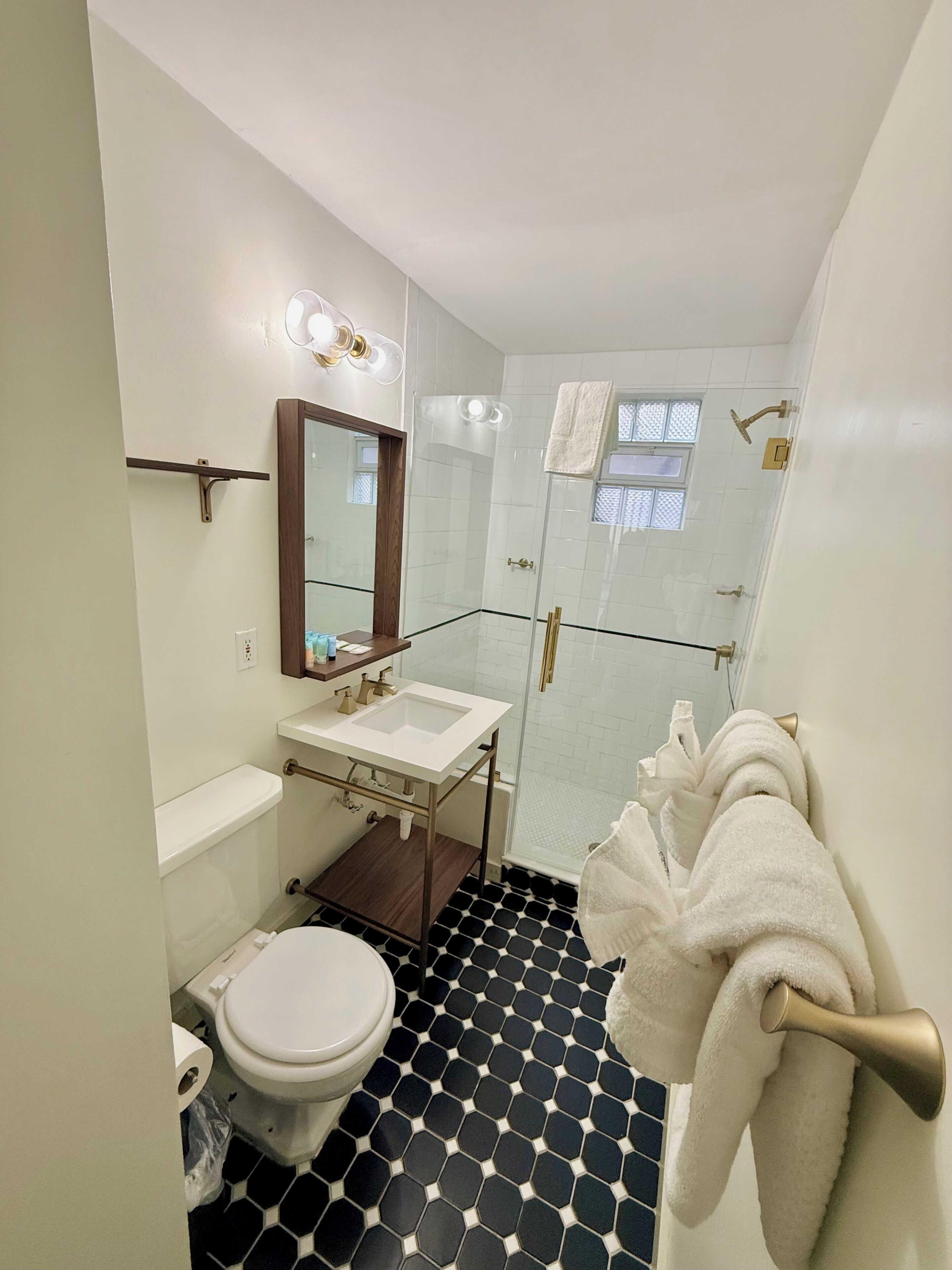 A bathroom with a toilet, sink, and shower.