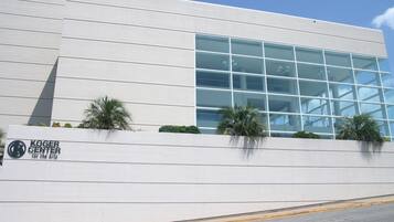 A modern building with a large glass facade and a sign reading "Koger Center for the Arts".