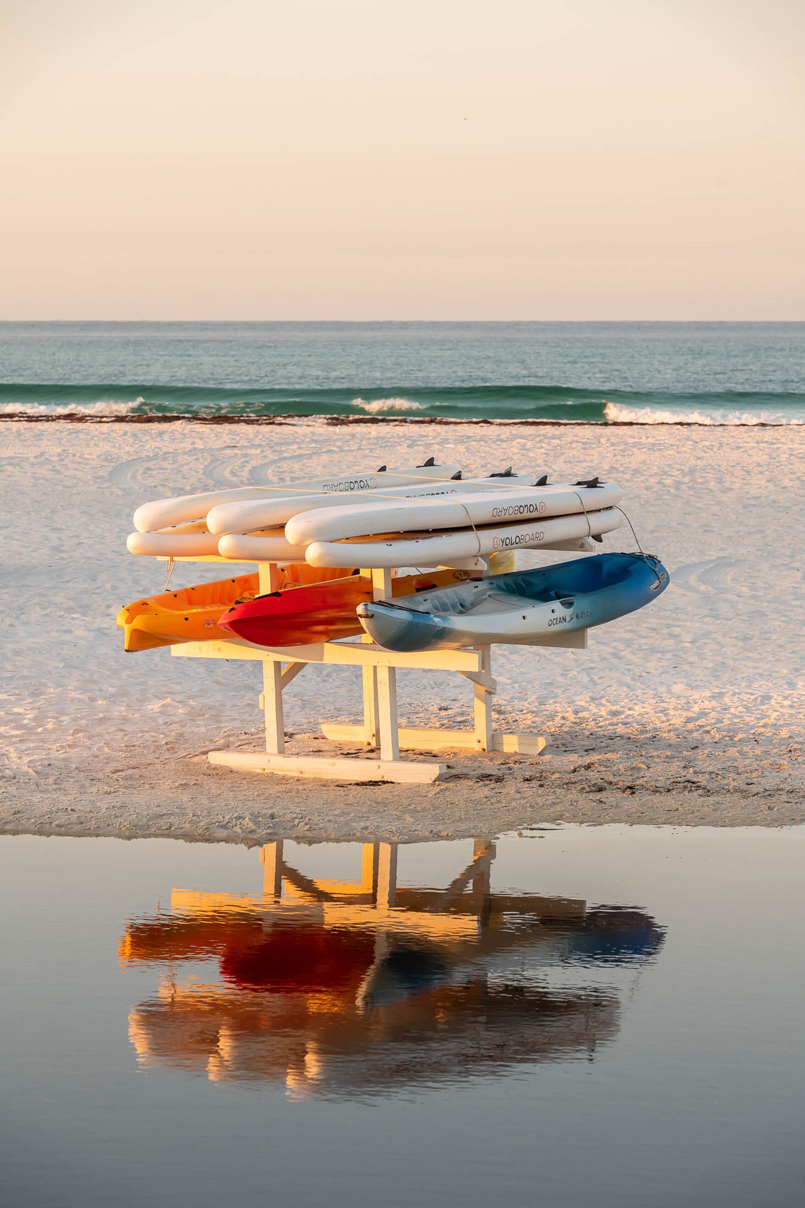A lifeguard stand with several life-saving devices on a beach.