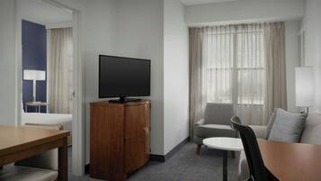 Premium bedding, desk, laptop workspace, blackout drapes