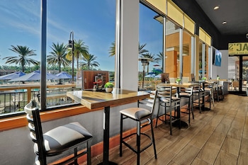 A gym with various exercise equipment, including treadmills, weight machines, and a mirrored wall. at Regal Oaks Resort Vacation Townhomes by IDILIQ