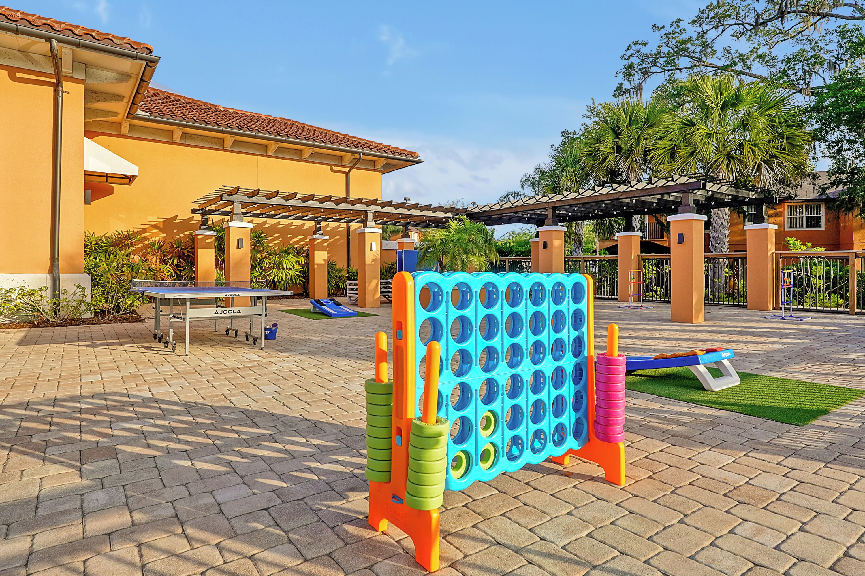 A children's play area with a Joolas table, a blue and pink ball pit, and a slide.