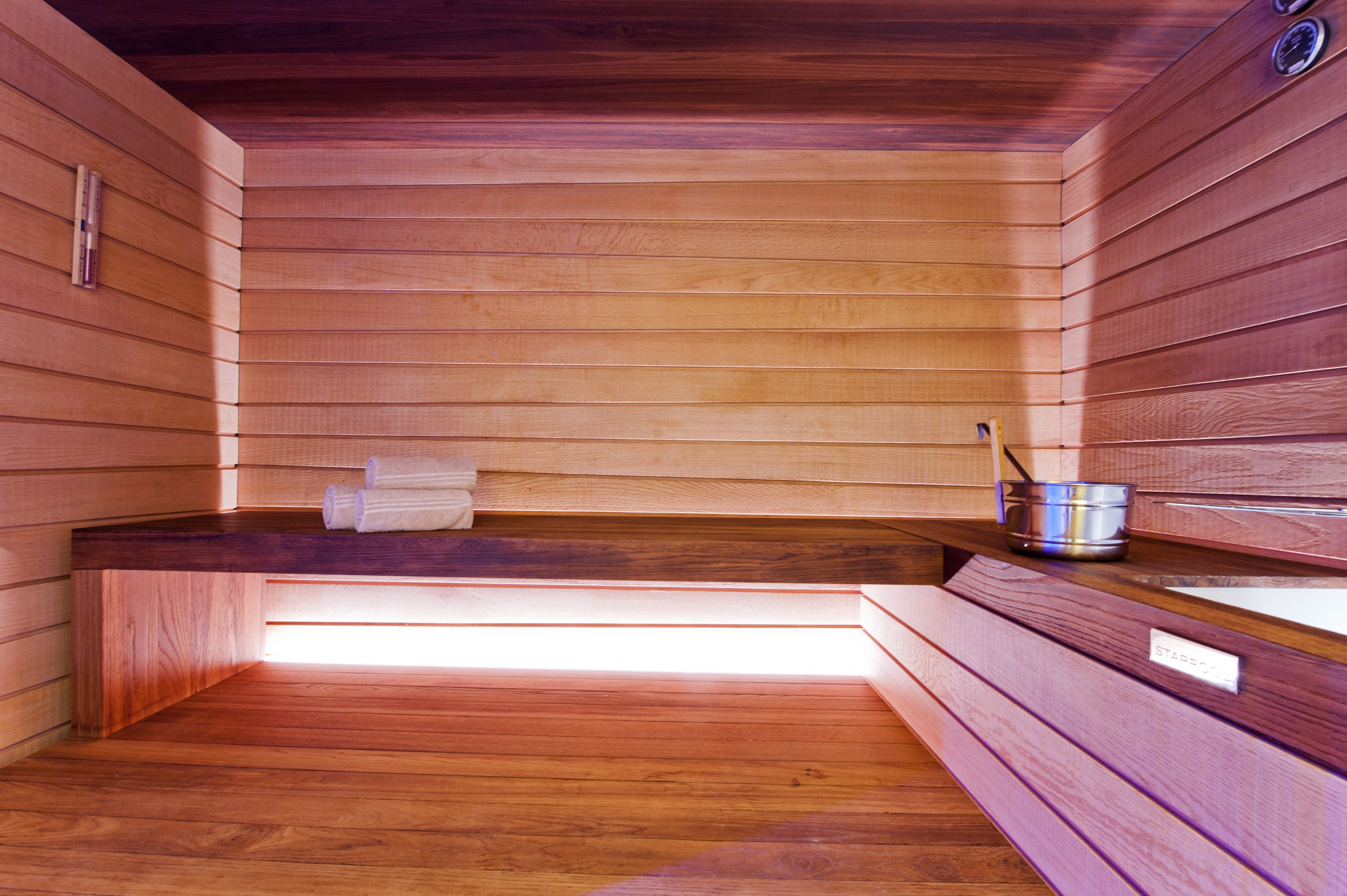 A wooden sauna with benches and a bench seat.