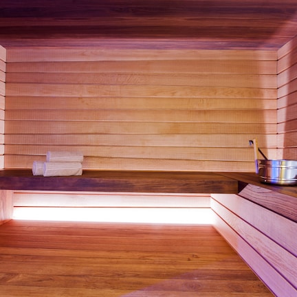 A wooden sauna with benches and a bench seat.