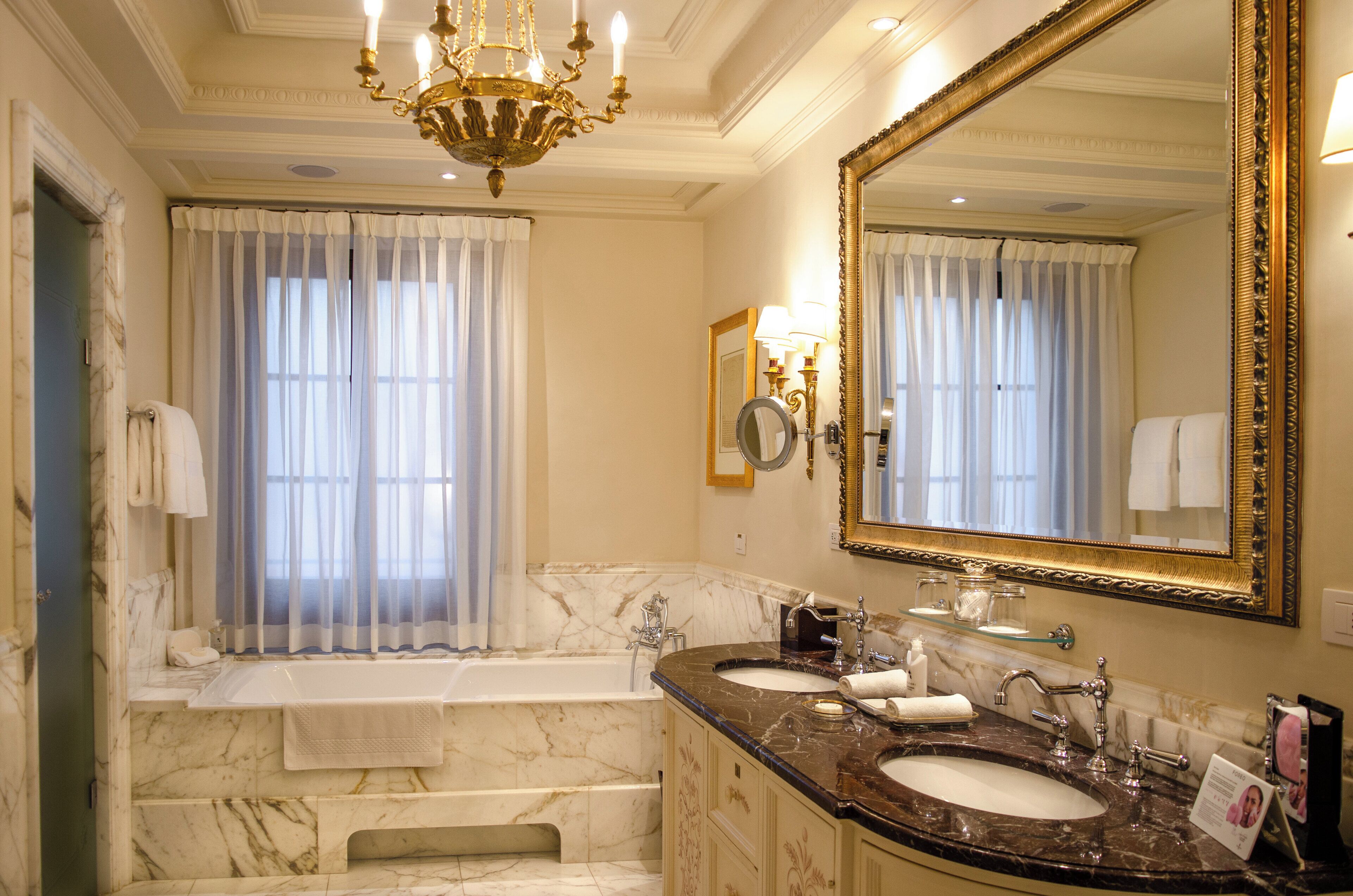 frescoed executive suite king bed | bathroom | separate bathtub and shower, deep-soaking bathtub, designer toiletries
