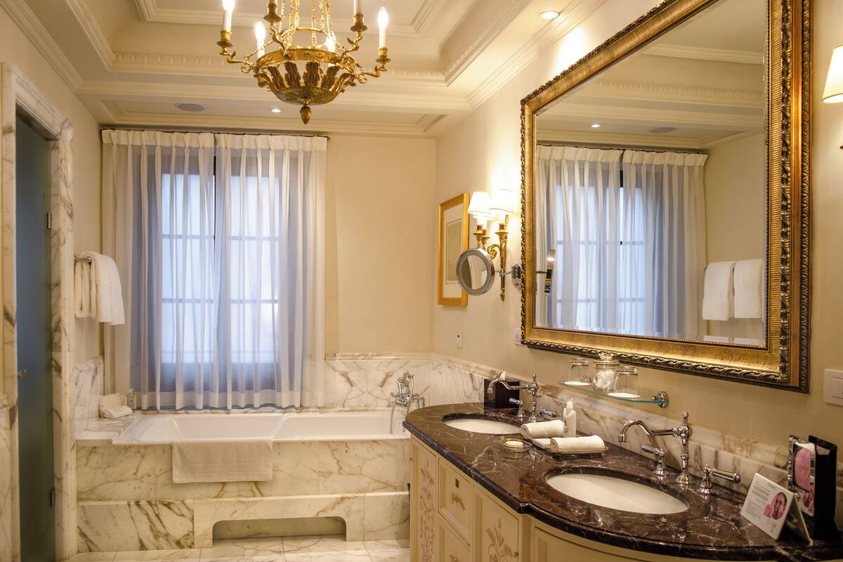 frescoed executive suite king bed | bathroom | separate bathtub and shower, deep-soaking bathtub, designer toiletries