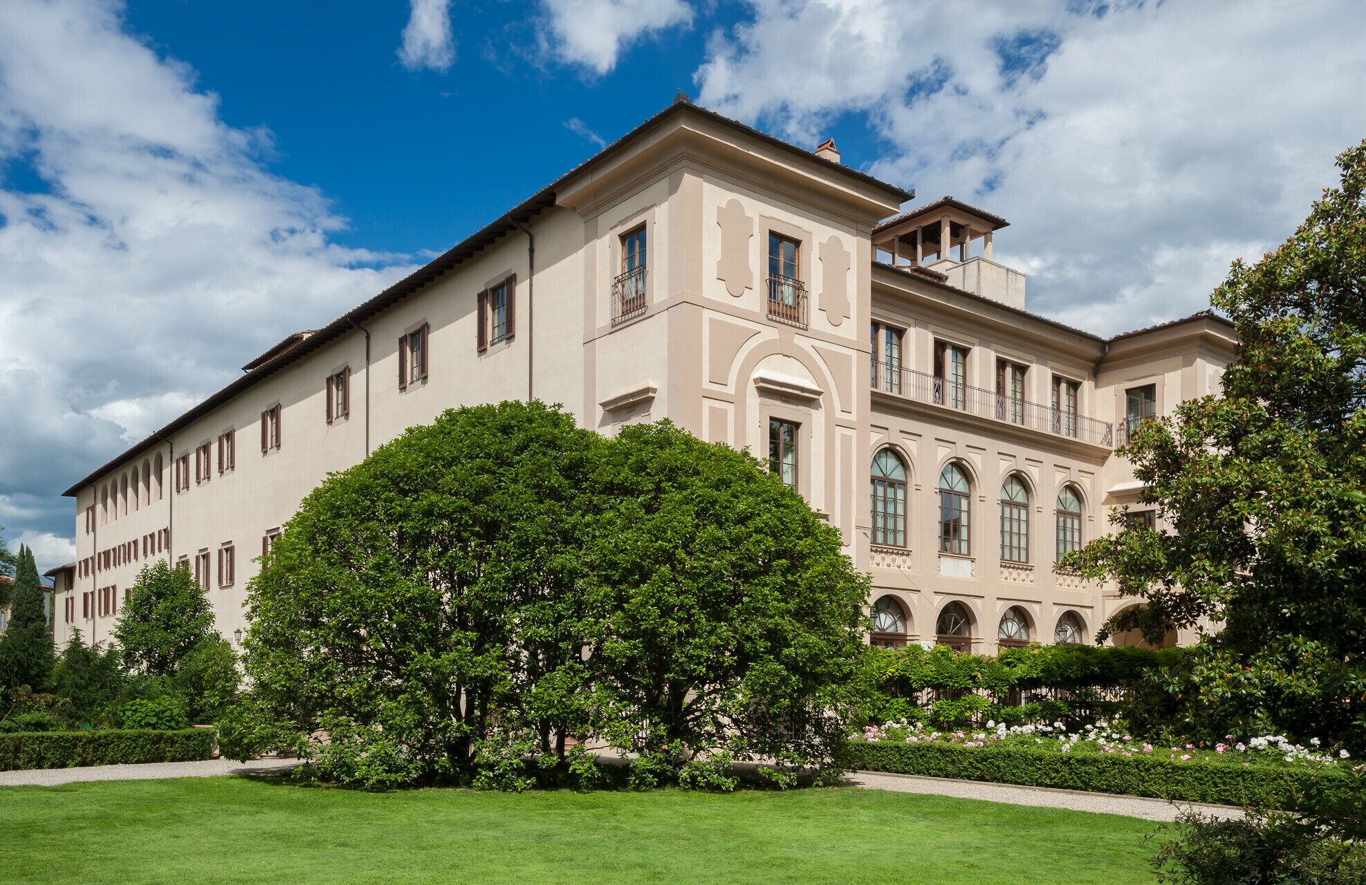 A large, classical building with symmetrical architecture, multiple windows, and a central entrance.