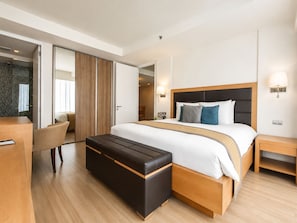 A modern hotel room with a large bed, a wooden bench, a desk, and a chair. - Oakwood Residence Sukhumvit 24 Bangkok (Bangkok)