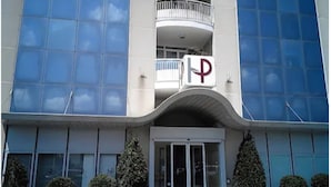 A modern building with a prominent 'P' logo, large glass windows, and a curved entrance. - Papillo Hotels & Resorts Roma (Rome)