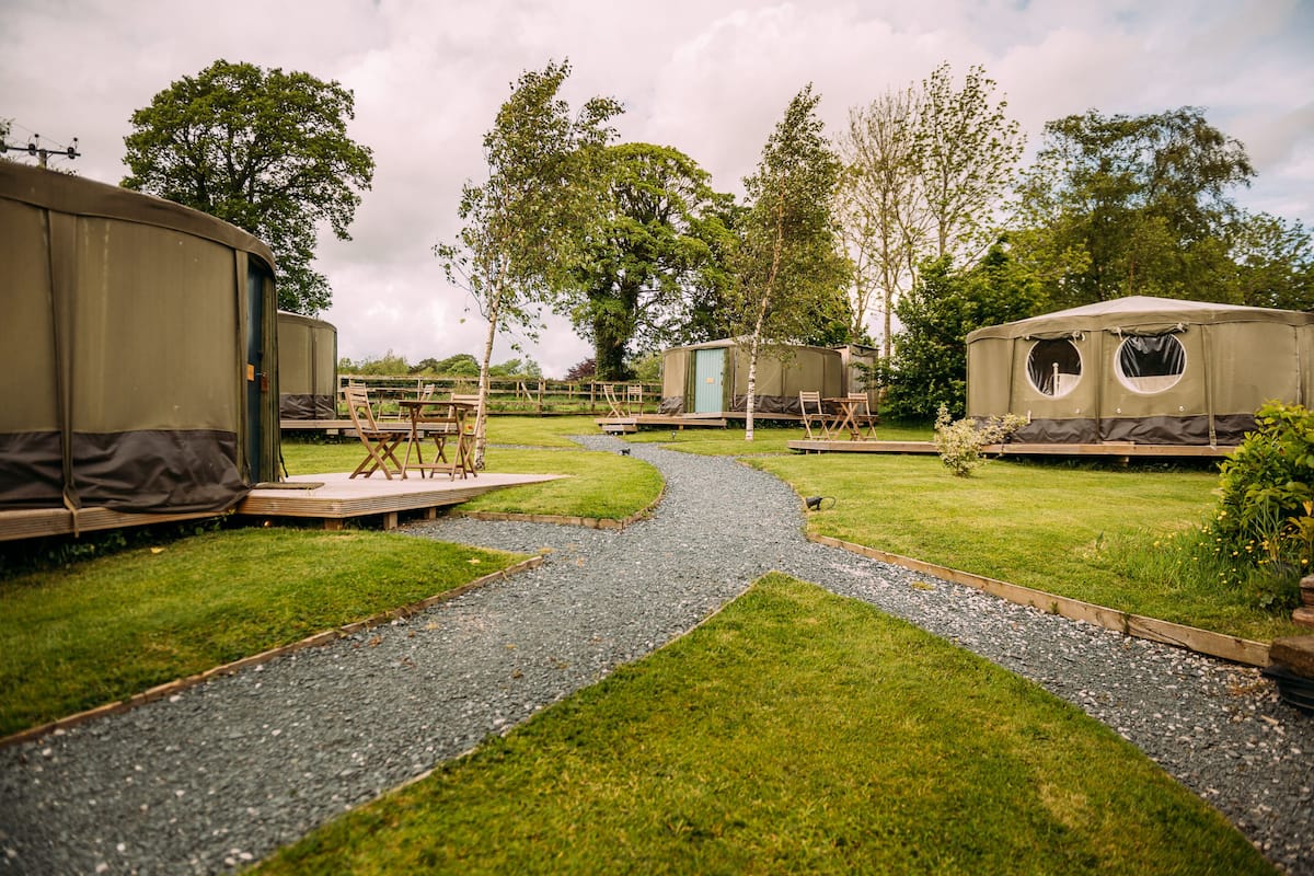 A campsite with tents and a gravel path.