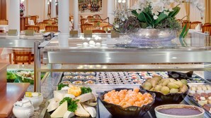 A buffet area with various food items, including fruits, cheeses, and seafood. - Ensana Centralni Lazne – Maria Spa (Marianske Lazne)