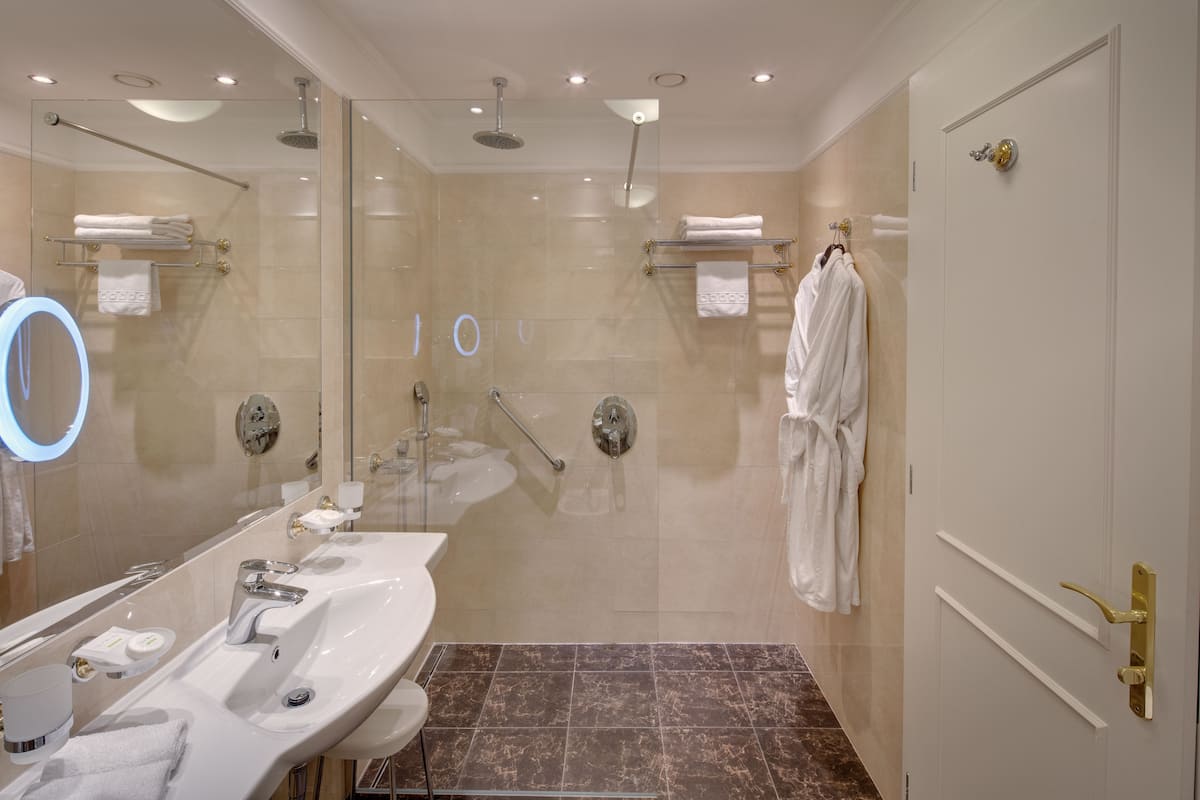 deluxe double room with wellness and fitness access | bathroom | free toiletries, hair dryer, bathrobes, slippers