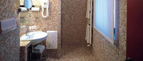 A bathroom with a tiled floor, a sink, a mirror, a towel rack, and a radiator.