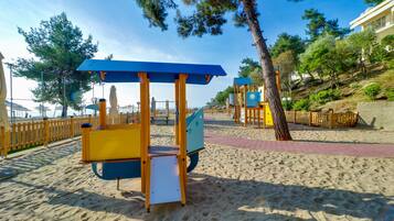 Children can play on the swing set and climbing frame in this beachside playground.