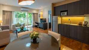 A modern living room with a dining table, sofa, and a TV.