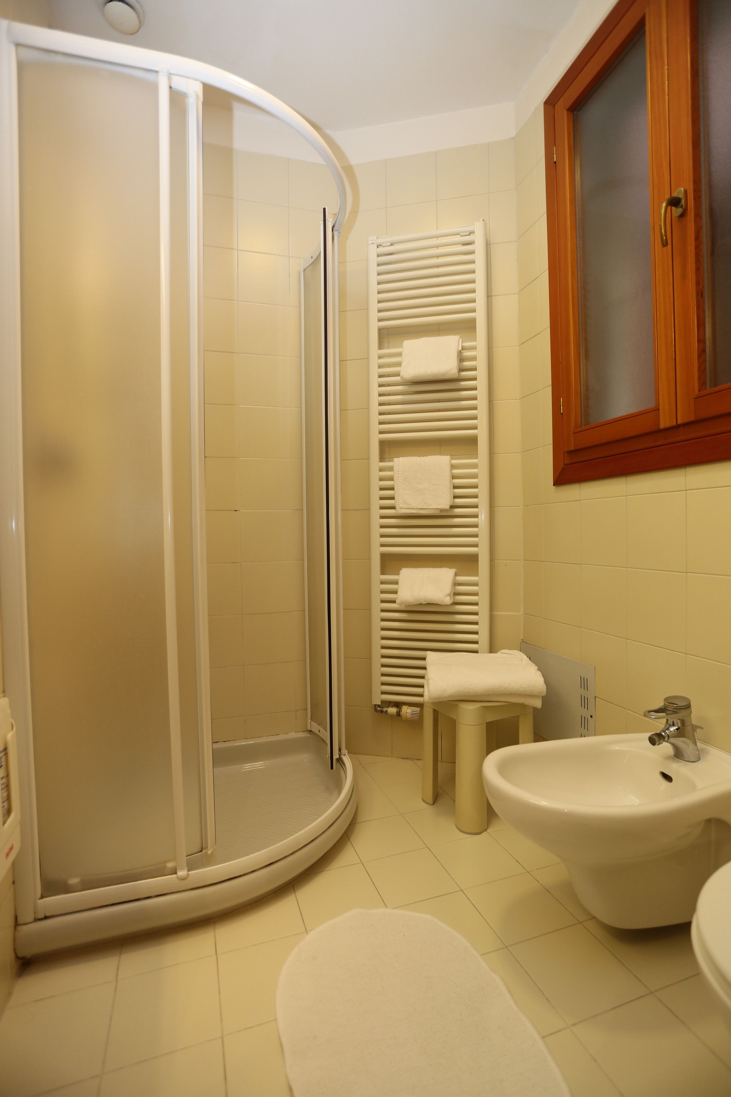 economy double room | bathroom | rainfall showerhead, hair dryer, bidet, towels
