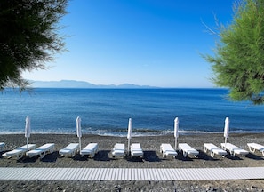 Private beach, black sand, sun loungers, beach umbrellas