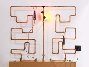 A copper pipe structure with valves and a switchboard. - ibis Styles Macon Centre (Macon)