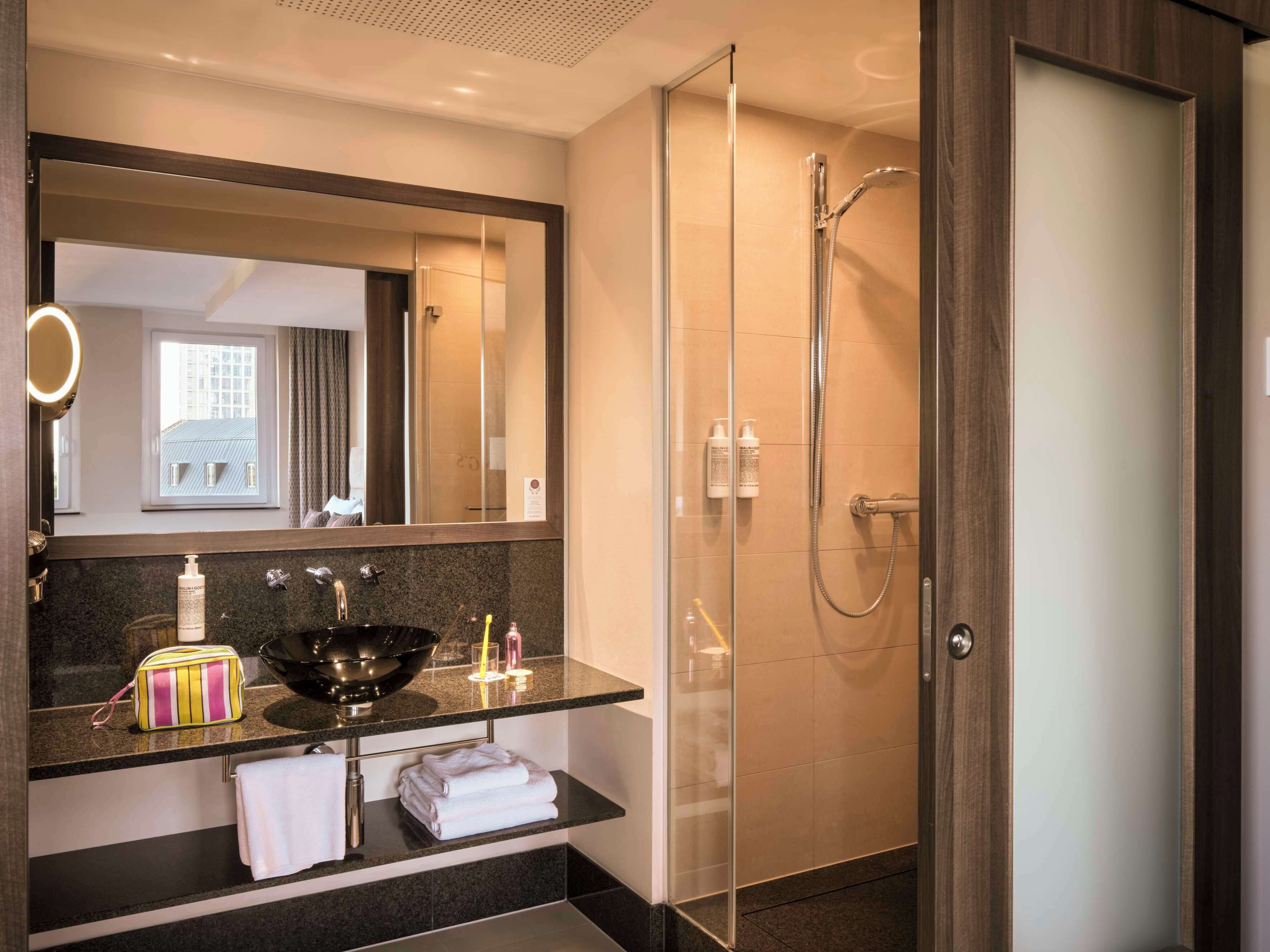 superior plus king room | bathroom | designer toiletries, hair dryer, towels, soap