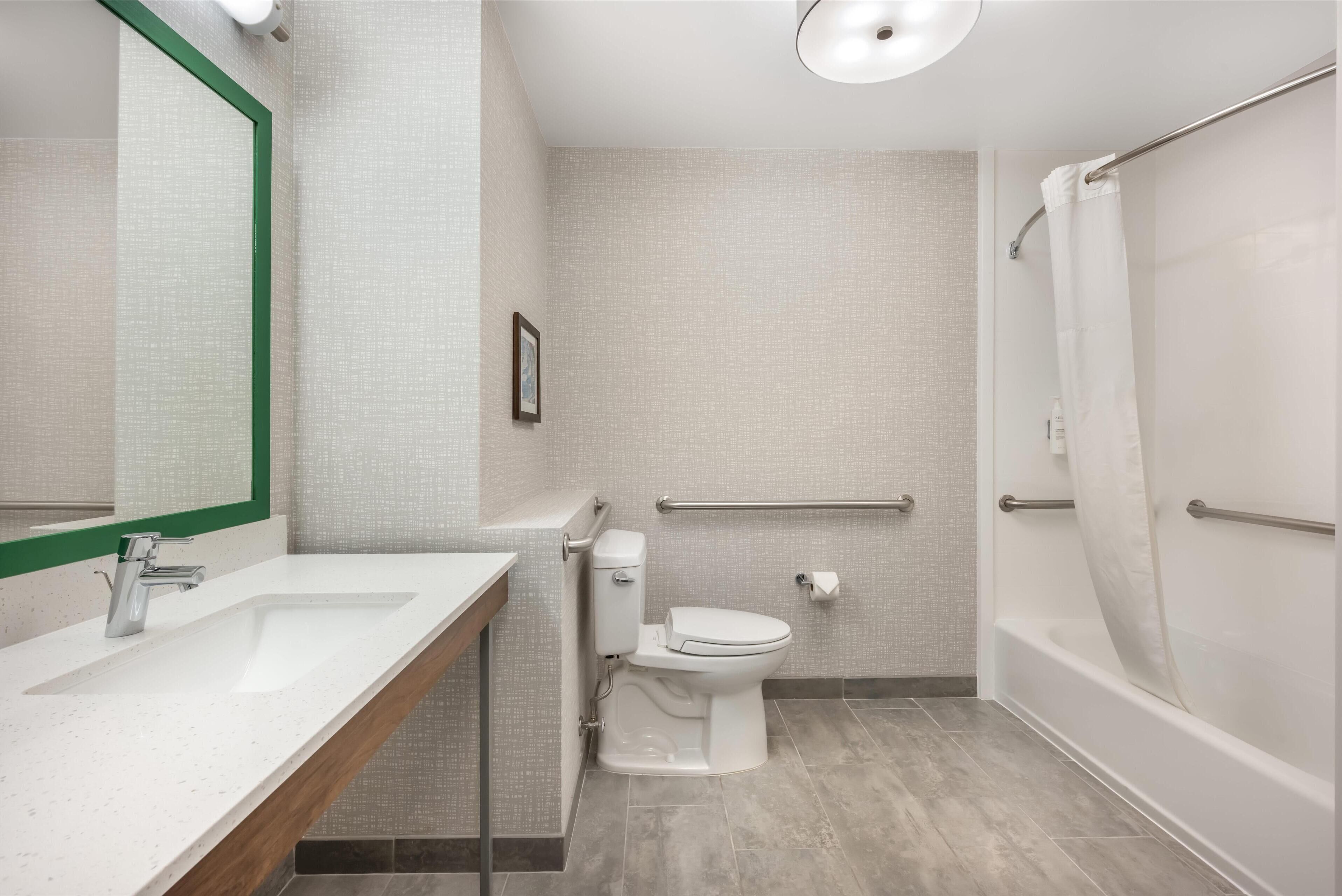 room, 1 king bed, accessible, bathtub (mobility & hearing) | bathroom | bathtub, hair dryer, towels