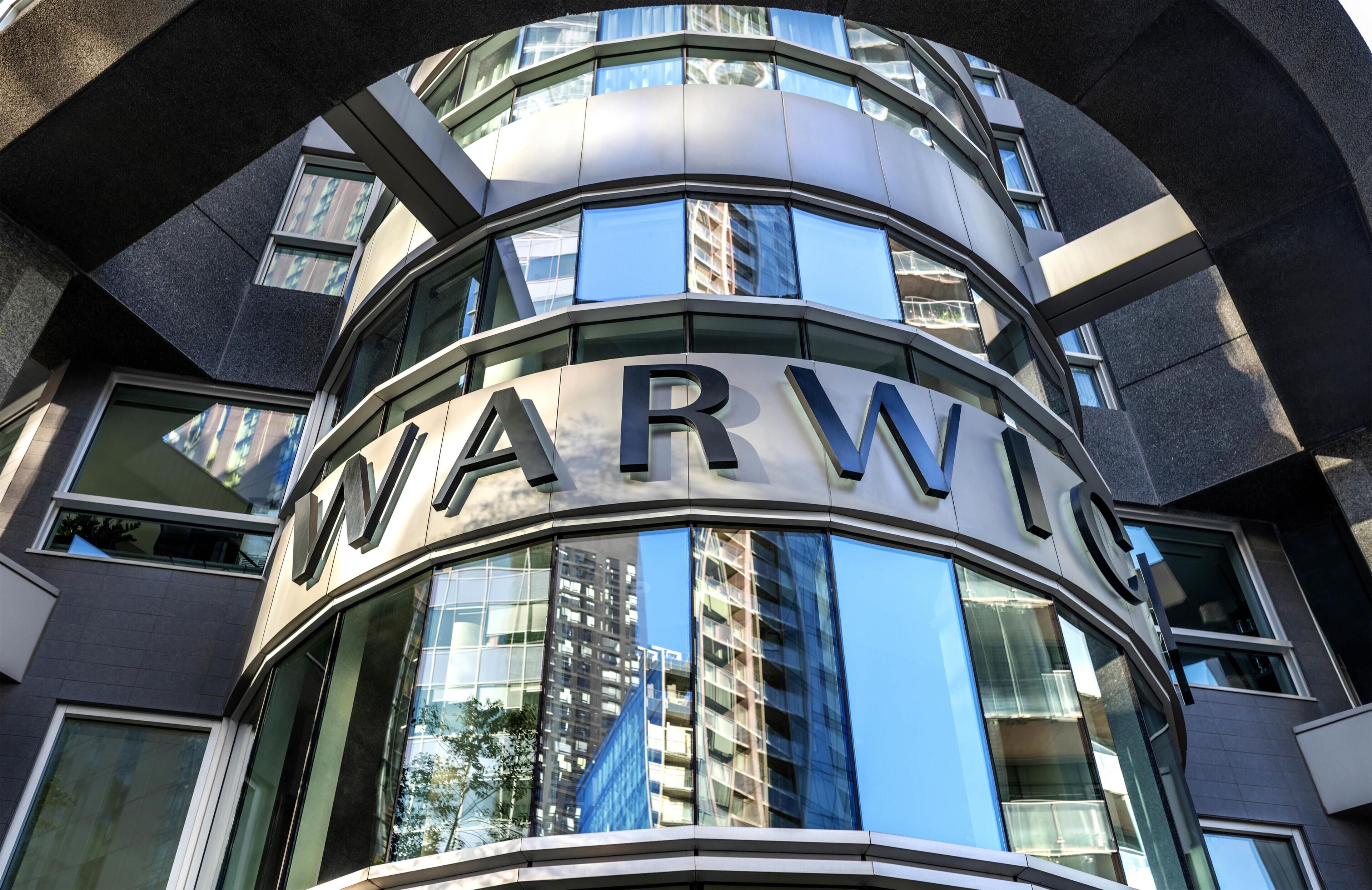 A building with a curved facade and the letters 'WARW' prominently displayed.
