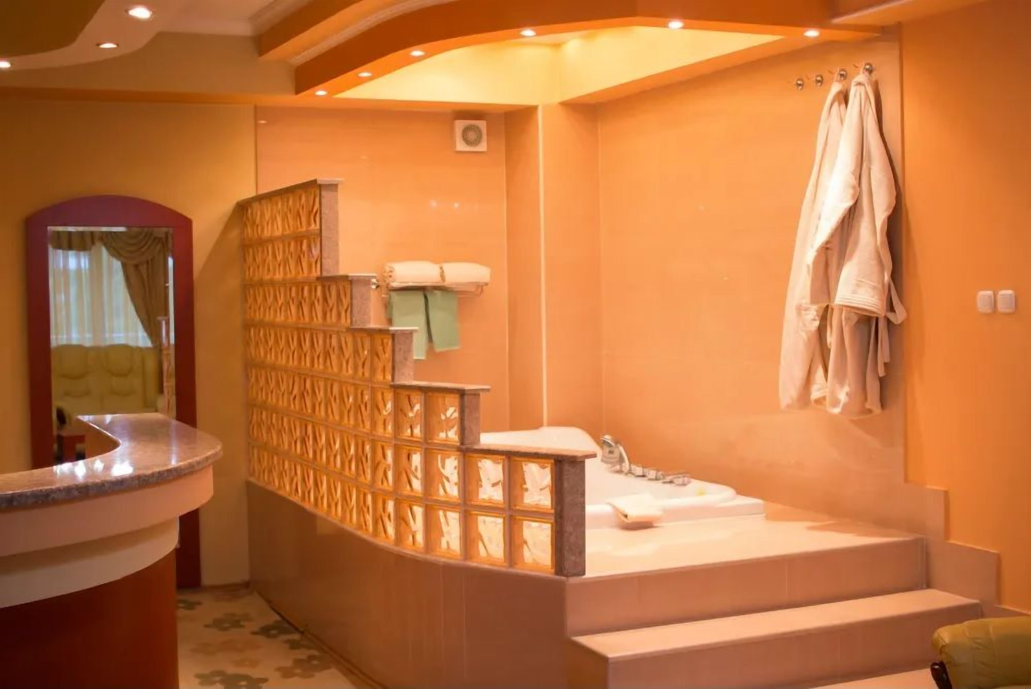 A bathroom with a bathtub, a sink, and a towel rack.